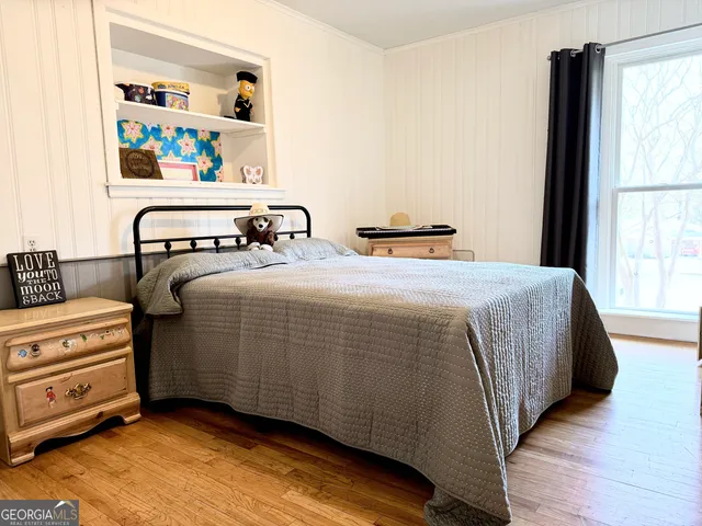 a bedroom with a bed a couch and a chandelier