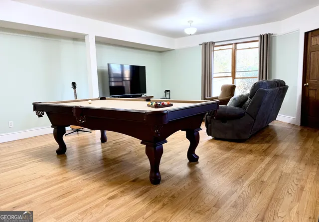 a kitchen with a sink a refrigerator and white cabinets