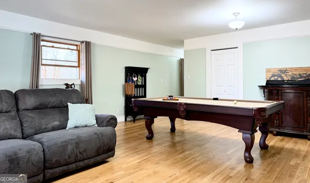 a view of a dining room with furniture and wooden floor