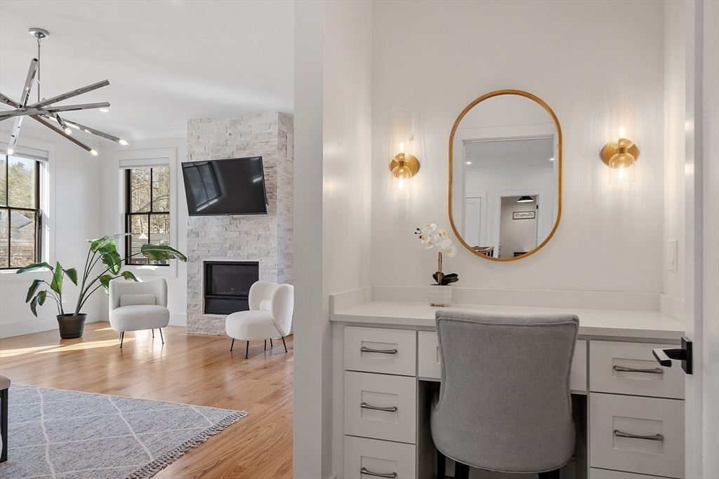 38 Webster Road Lexington, MA 02421 - Photo 24 of 42 a living room with furniture a fireplace a flat screen tv and potted plant