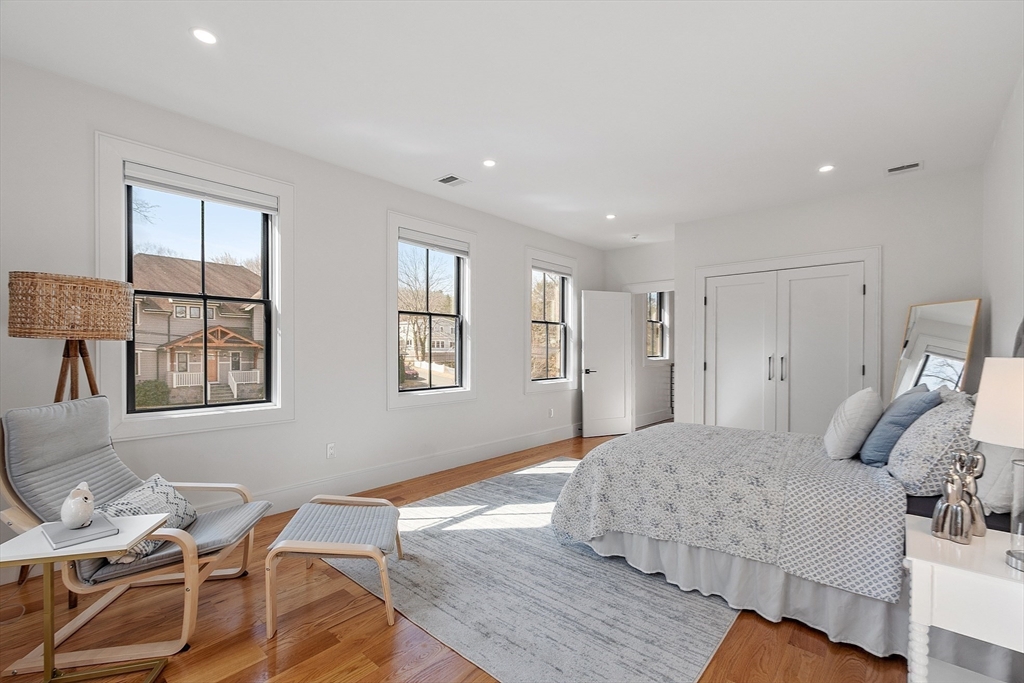 38 Webster Road Lexington, MA 02421 - Photo 28 of 42 a bedroom with a bed and wooden floor