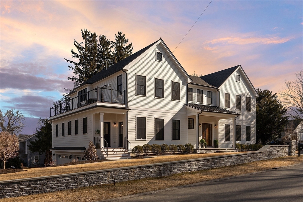 38 Webster Road Lexington, MA 02421 - Photo 40 of 42 a view of a white house with large windows next to a road