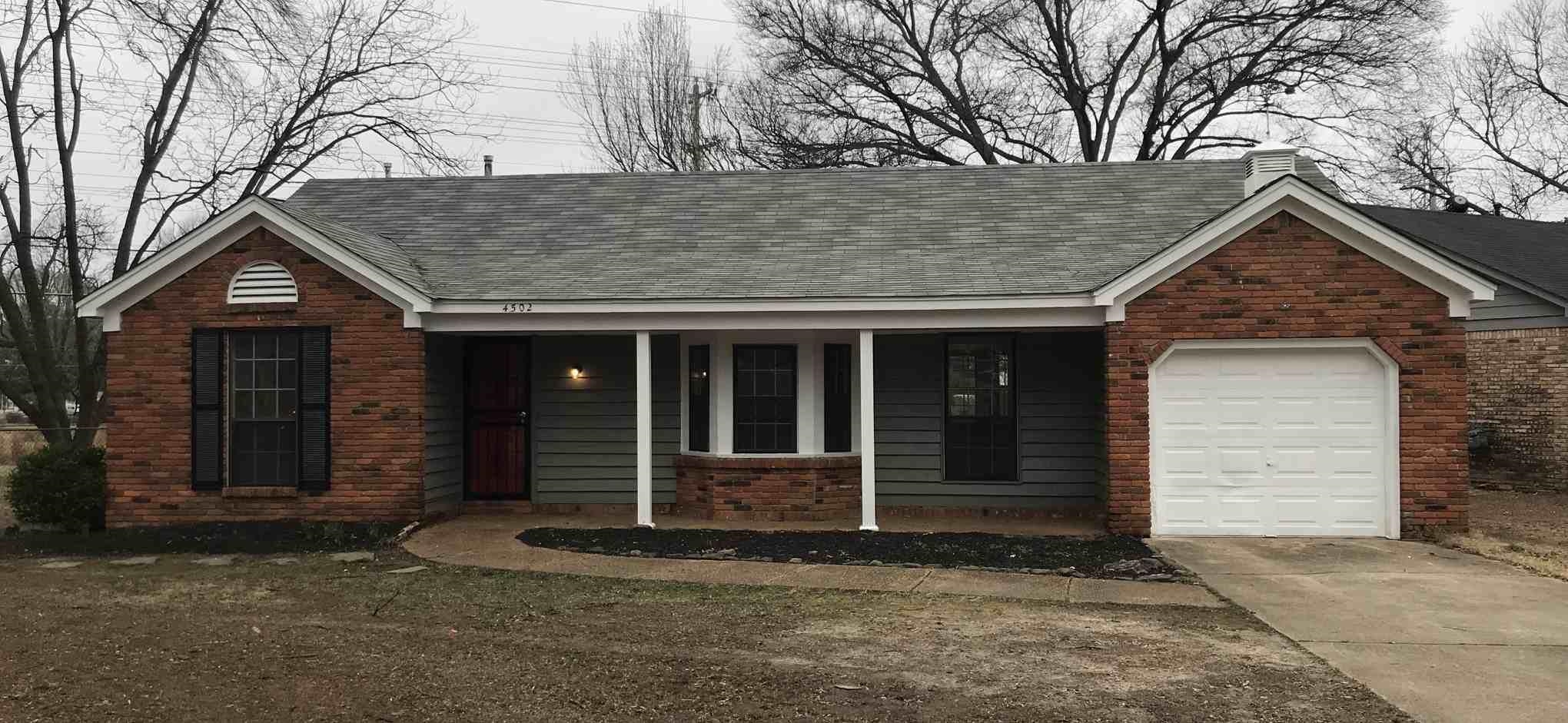 4502 Cottonwood Road Memphis, TN 38118 - Photo 1 of 16 Brick and siding exterior featuring a covered porch with white columns, bay window, attached garage, and a curved concrete walkway