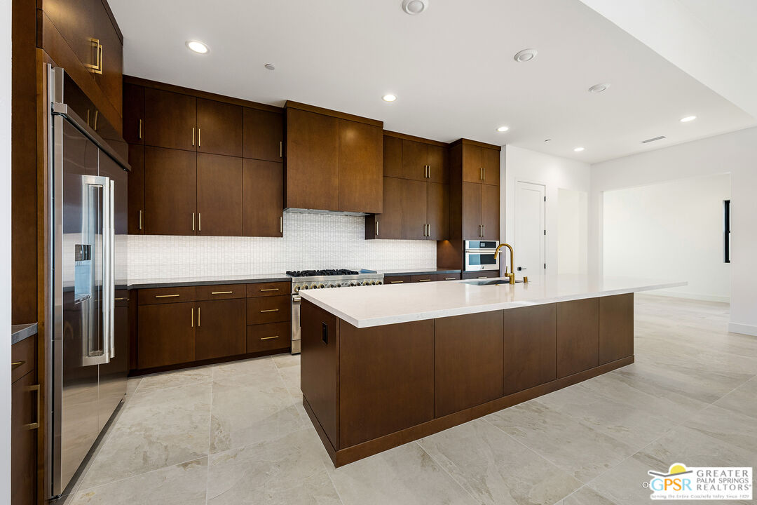 4 Heliotrope Avenue, Unit LOT #299 Rancho Mirage, CA 92270 - Photo 5 of 18 a large kitchen with stainless steel appliances a large counter top