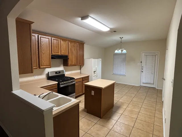 a kitchen with a cabinets and appliances
