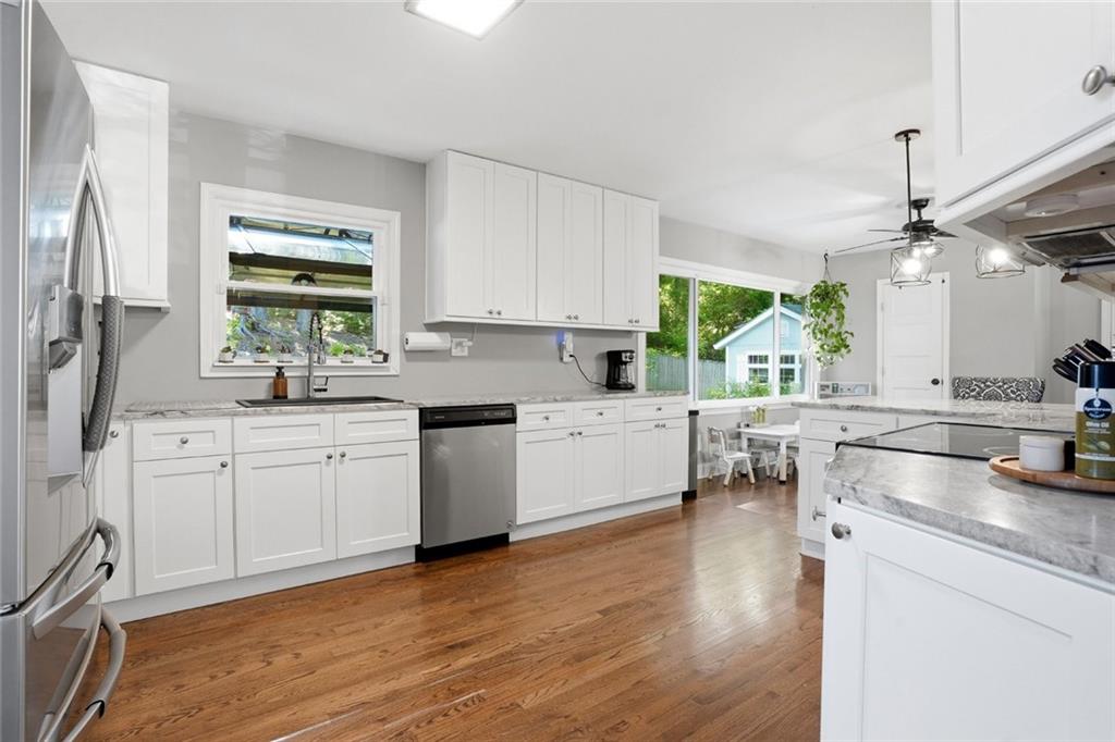 1430 Thomas Road Decatur, GA 30030 - Photo 12 of 42 a kitchen with a sink cabinets stainless steel appliances and a window
