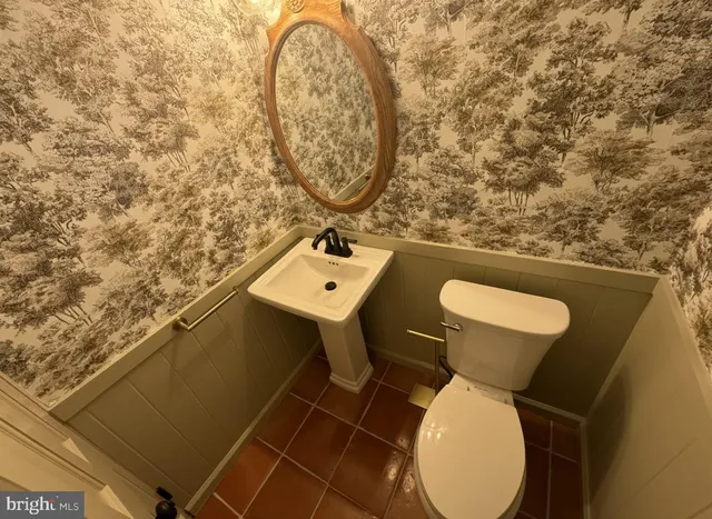 a bathroom with a toilet and a sink
