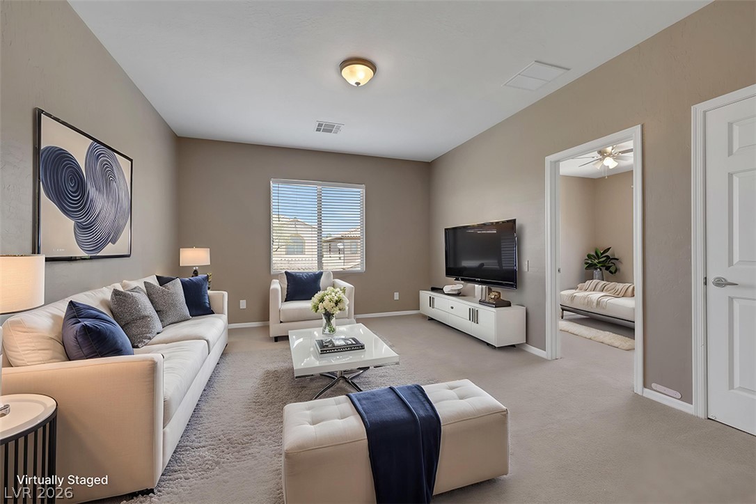 2501 Bechamel Place Henderson, NV 89044 - Photo 23 of 50 A comfortable living area with high ceilings provides a serene space for relaxation or entertainment.