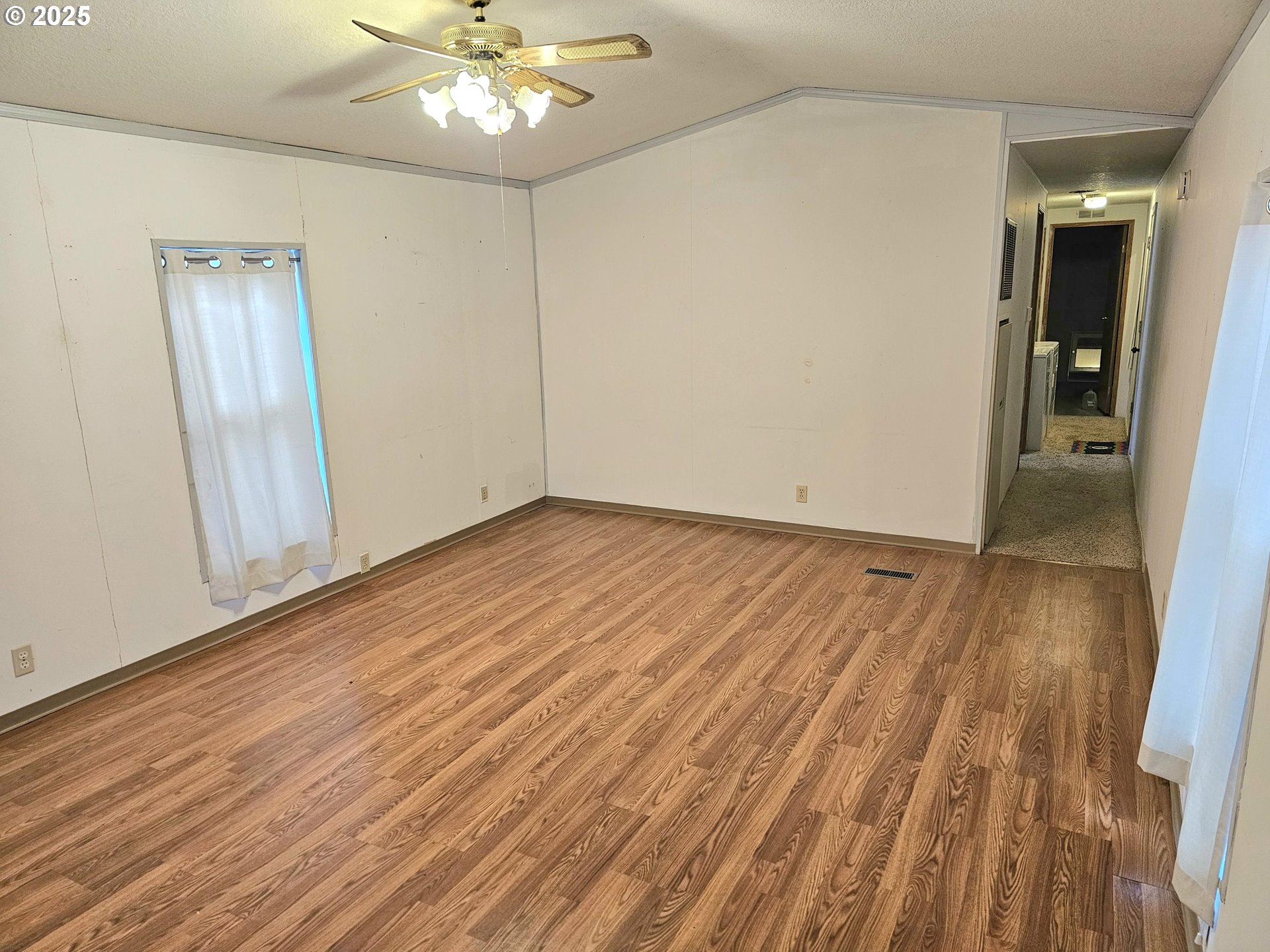 612 North Cascade Drive, Unit 25 Woodburn, OR 97071 - Photo 4 of 17 a view of an empty room with wooden floor
