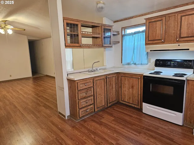 a kitchen with stainless steel appliances granite countertop a stove a sink and a microwave