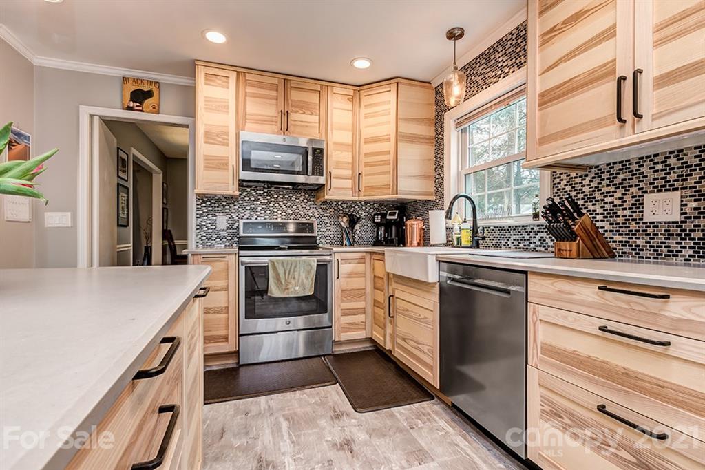 9638 Watergate Road Charlotte, NC 28270 - Photo 11 of 25 a kitchen with stainless steel appliances white cabinets and a stove top oven