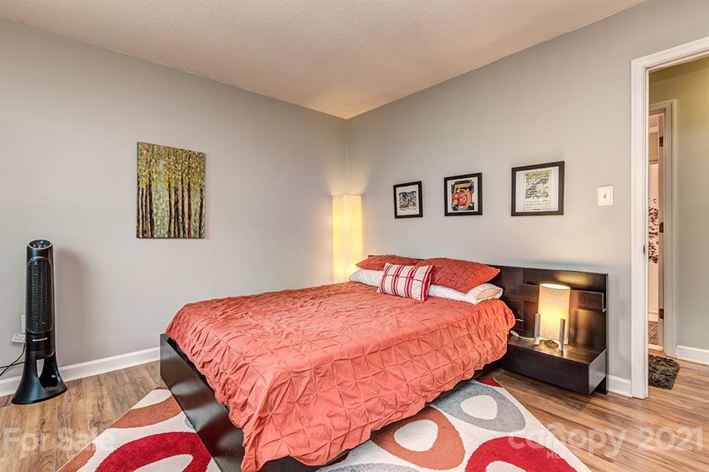 9638 Watergate Road Charlotte, NC 28270 - Photo 16 of 25 a bedroom with a bed and a lamp on dresser
