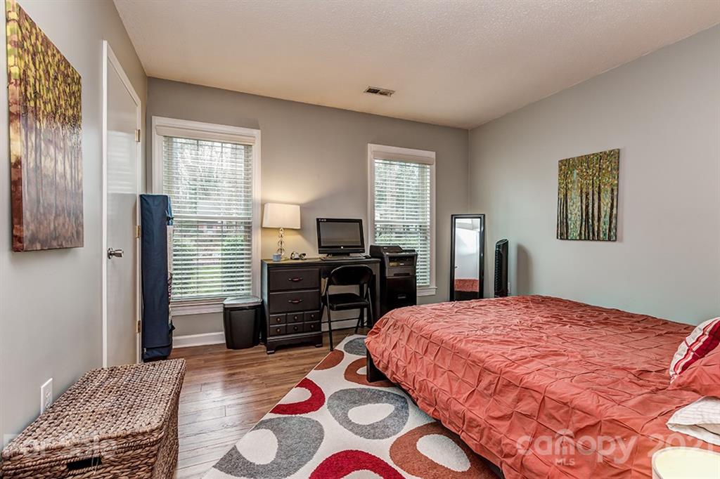 9638 Watergate Road Charlotte, NC 28270 - Photo 17 of 25 a bedroom with a bed and wooden floor