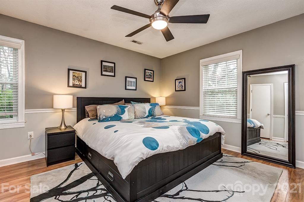 9638 Watergate Road Charlotte, NC 28270 - Photo 20 of 25 a bedroom with a bed and wooden floor
