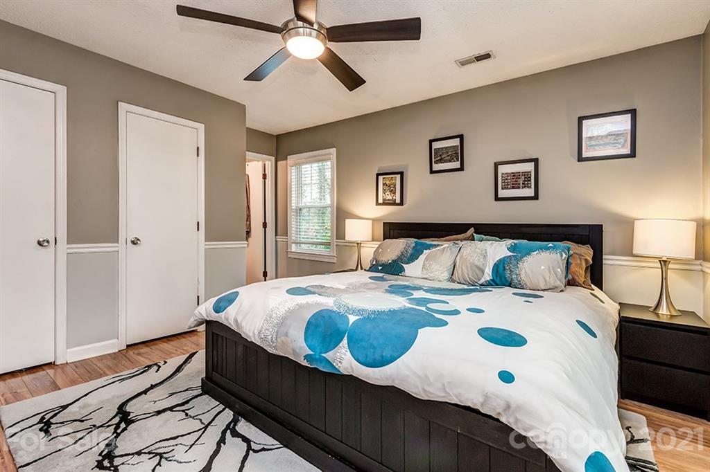 9638 Watergate Road Charlotte, NC 28270 - Photo 21 of 25 a bedroom with a bed and wooden floor