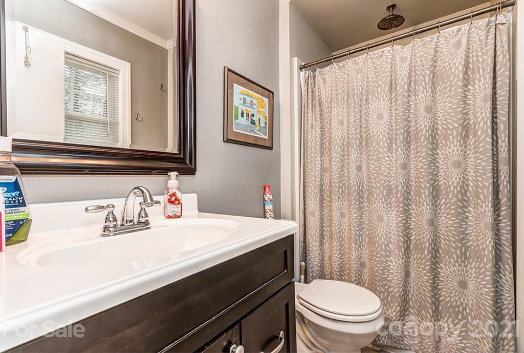 9638 Watergate Road Charlotte, NC 28270 - Photo 22 of 25 a bathroom with a sink a toilet and a mirror