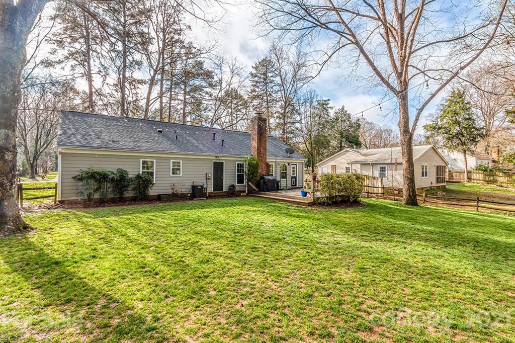 9638 Watergate Road Charlotte, NC 28270 - Photo 25 of 25 a view of a white house that has a tree back yard