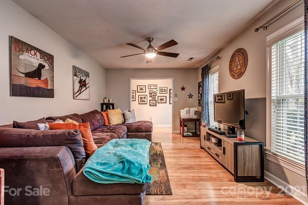 9638 Watergate Road Charlotte, NC 28270 - Photo 6 of 25 a living room with furniture and a flat screen tv