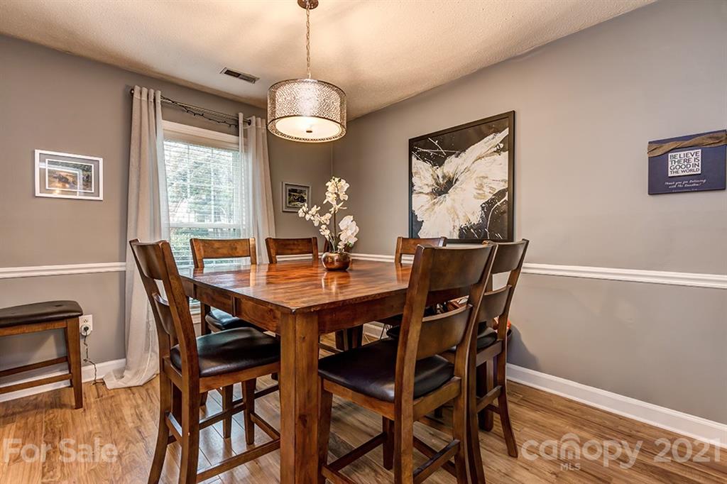 9638 Watergate Road Charlotte, NC 28270 - Photo 7 of 25 a view of a dining room with furniture window and wooden floor