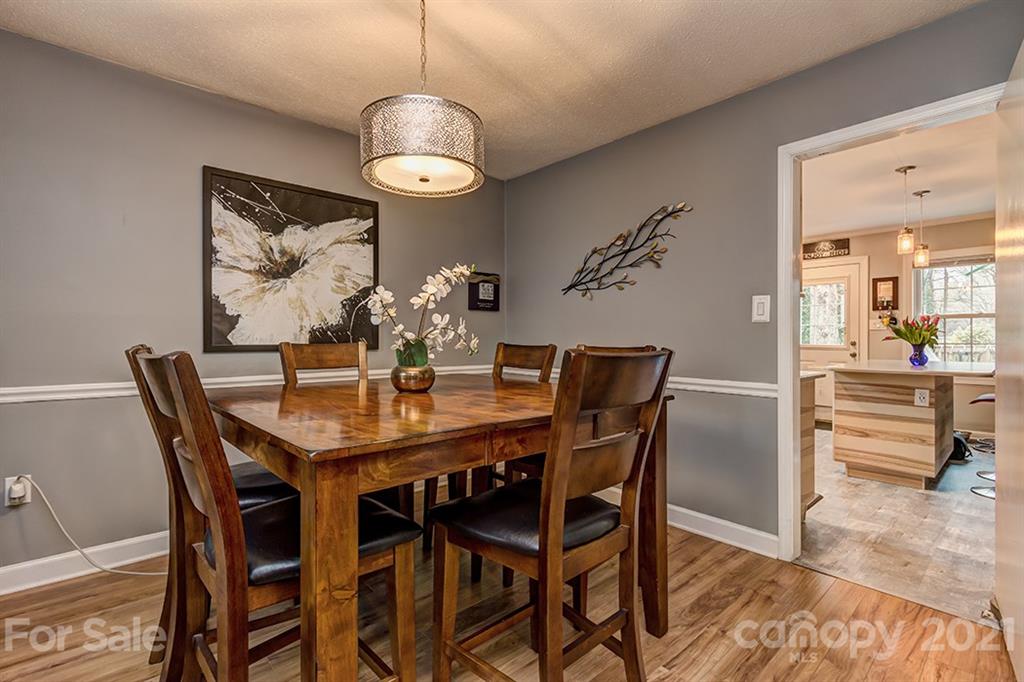 9638 Watergate Road Charlotte, NC 28270 - Photo 8 of 25 a view of a dining room with furniture and wooden floor