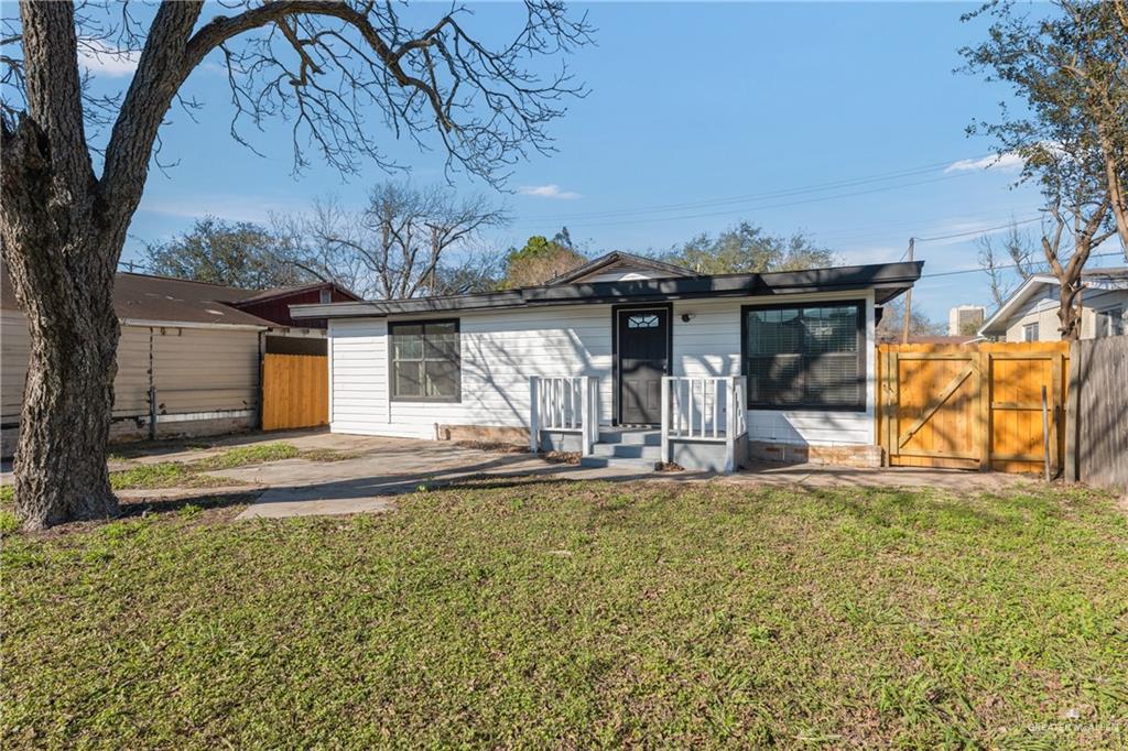 309 South 4th Street McAllen, TX 78501 - Photo 2 of 21 a view of a house with a large tree and a yard