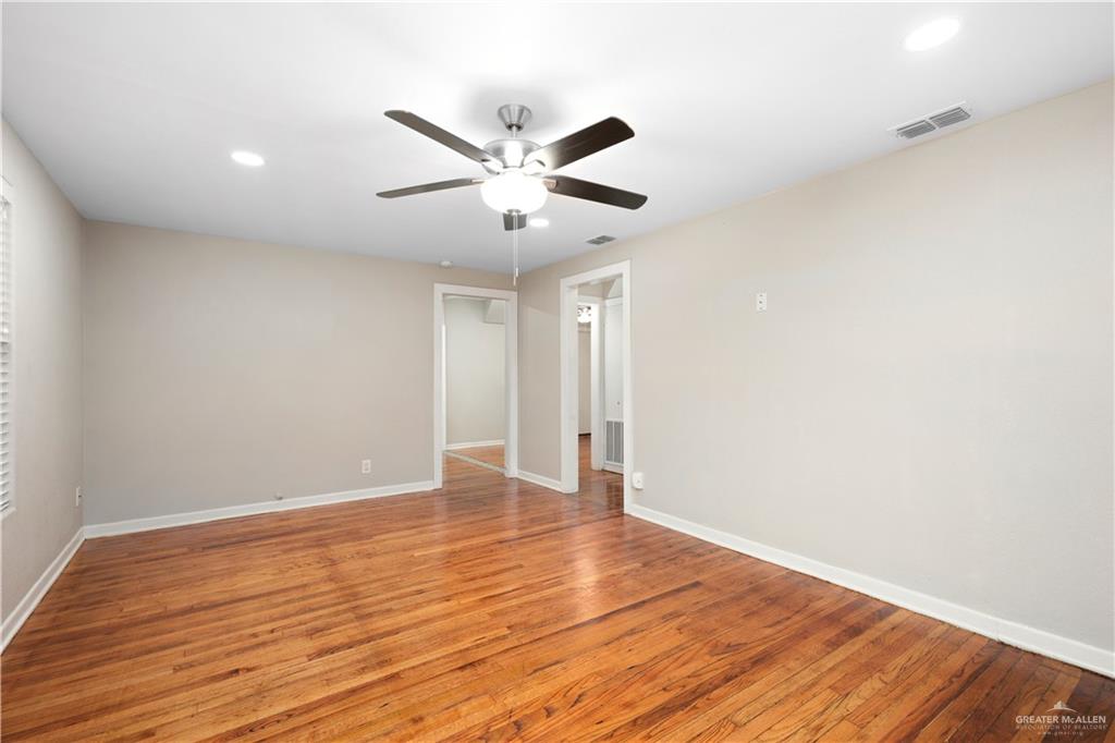 309 South 4th Street McAllen, TX 78501 - Photo 4 of 21 a view of an empty room with wooden floor