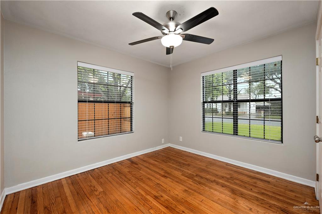 309 South 4th Street McAllen, TX 78501 - Photo 7 of 21 a view of an empty room with wooden floor and a window