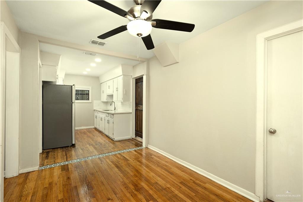 309 South 4th Street McAllen, TX 78501 - Photo 10 of 21 a view of a kitchen with a sink and a refrigerator