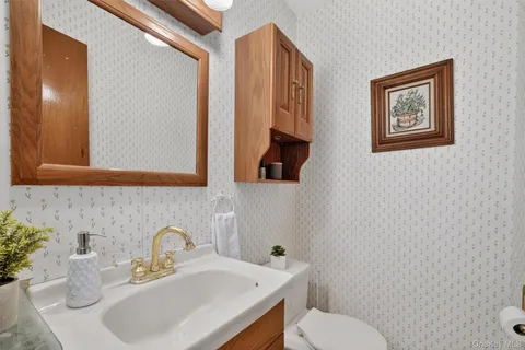 a bathroom with a toilet sink and mirror