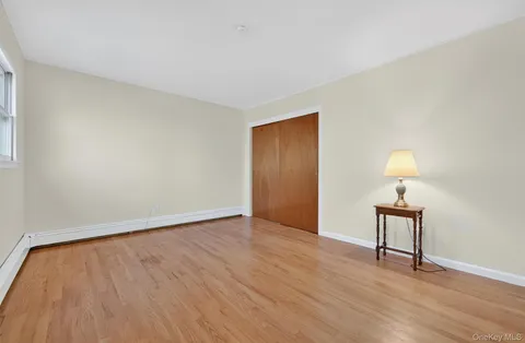a view of an empty room and wooden floor