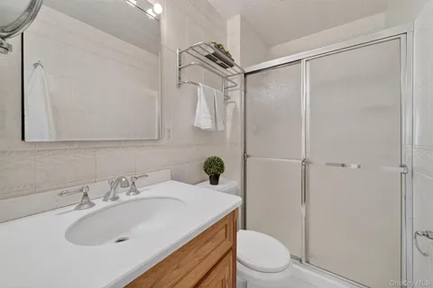a bathroom with a sink toilet and shower