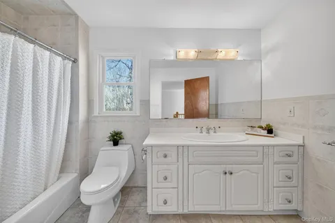 a bathroom with double sink and a mirror