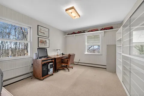 a view of workspace with window and cabinet