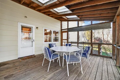a dining room with furniture window and wooden floor