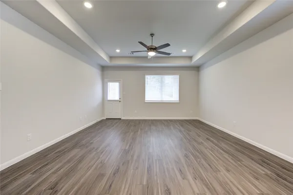 wooden floor in an empty room with a window