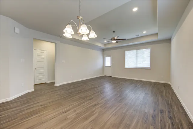 a view of kitchen with granite countertop cabinets and refrigerator