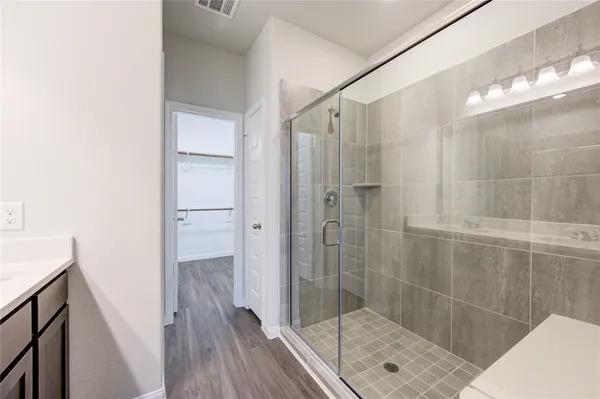 a bathroom with a double vanity sink and a mirror