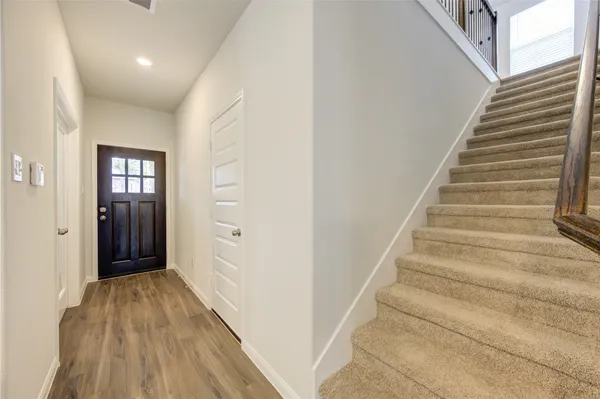 a view of entryway with wooden floor and stairs