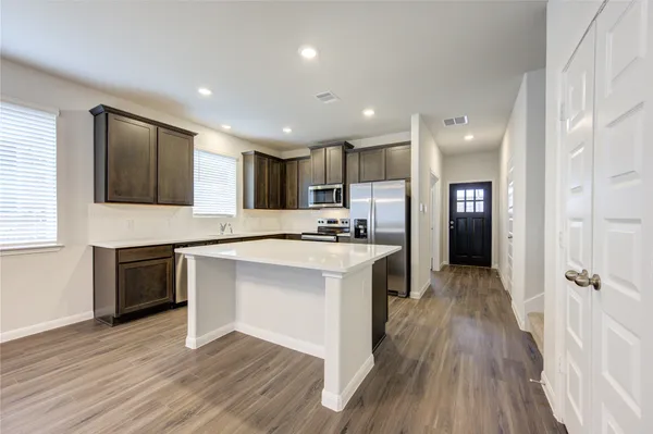 a kitchen with a sink stove and refrigerator