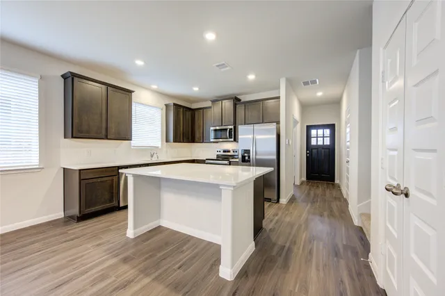 a kitchen with a sink stove and refrigerator