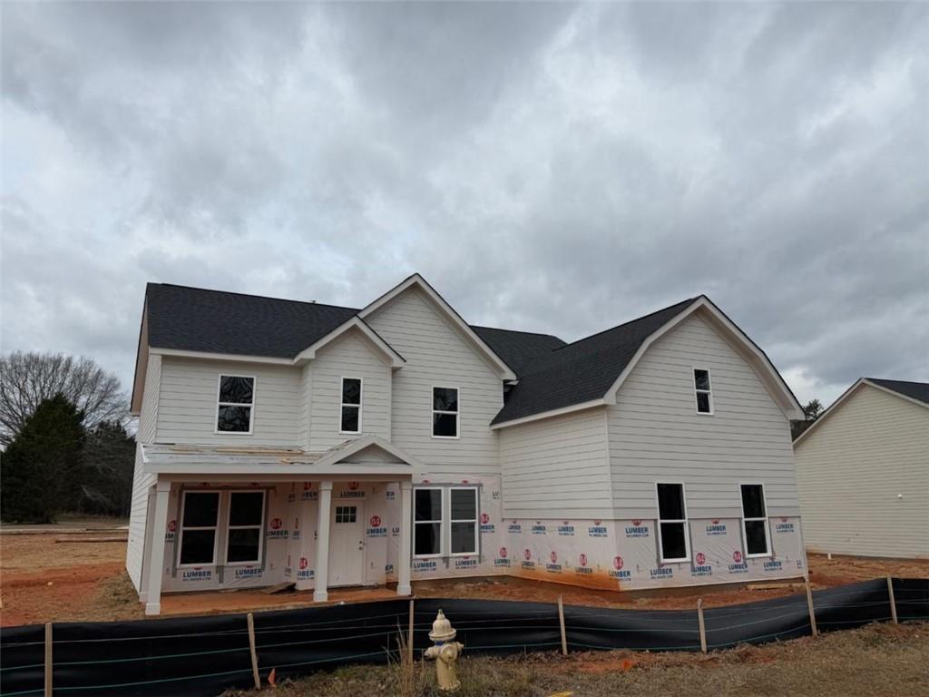a view of a house with a backyard and porch