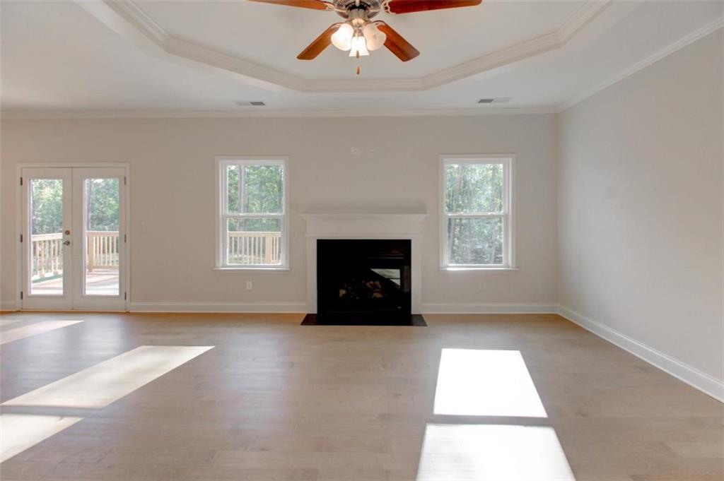 41 Woodland Road Covington, GA 30016 - Photo 12 of 35 an empty room with windows and fireplace