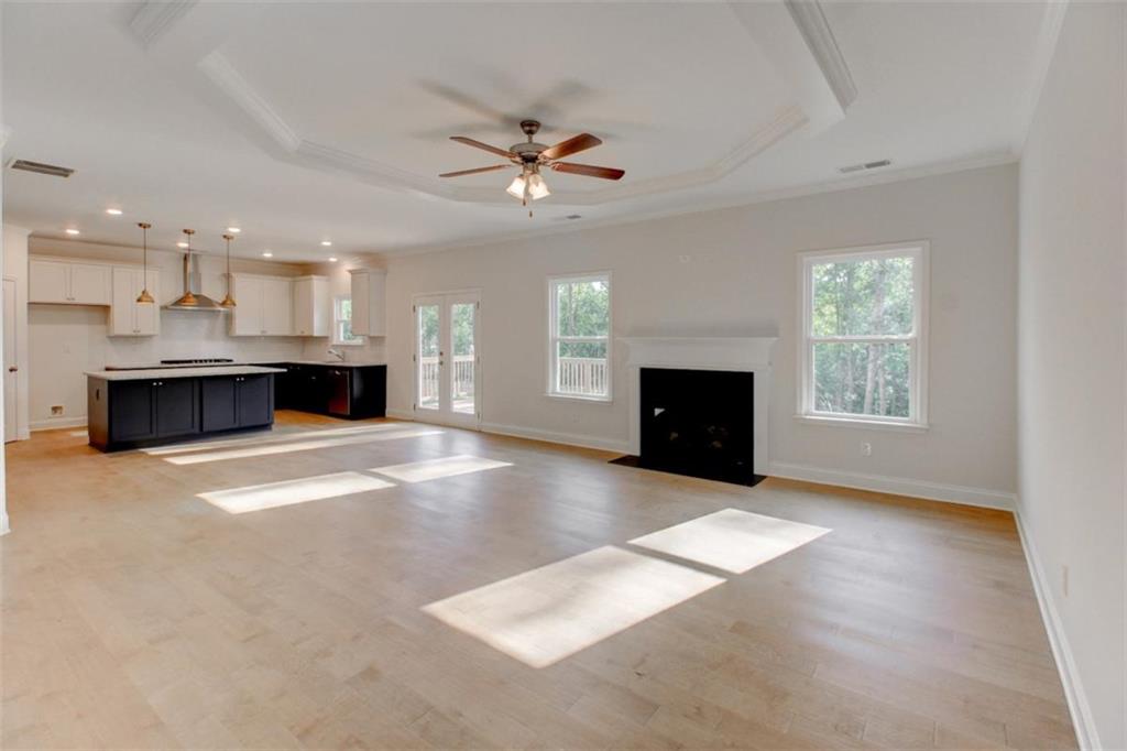 41 Woodland Road Covington, GA 30016 - Photo 13 of 35 view of a livingroom with a fireplace a ceiling fan and wooden floor