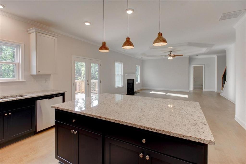 41 Woodland Road Covington, GA 30016 - Photo 16 of 35 a kitchen with kitchen island a counter space appliances and a window