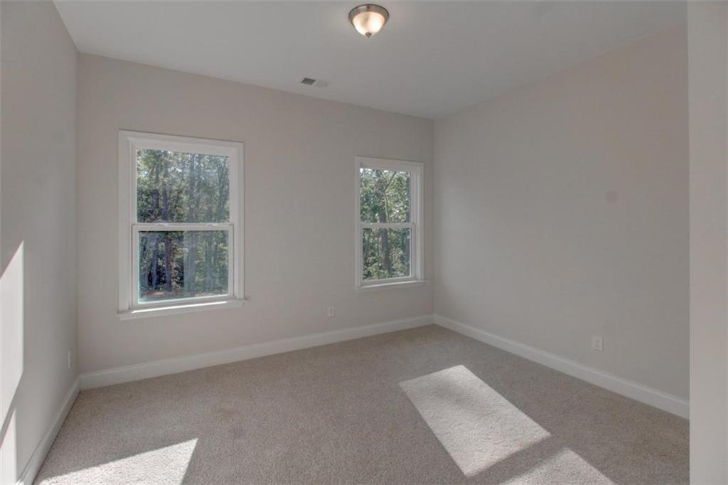 41 Woodland Road Covington, GA 30016 - Photo 18 of 35 an empty room with a window