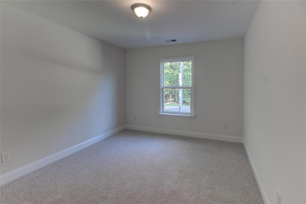 41 Woodland Road Covington, GA 30016 - Photo 35 of 35 an empty room with a window