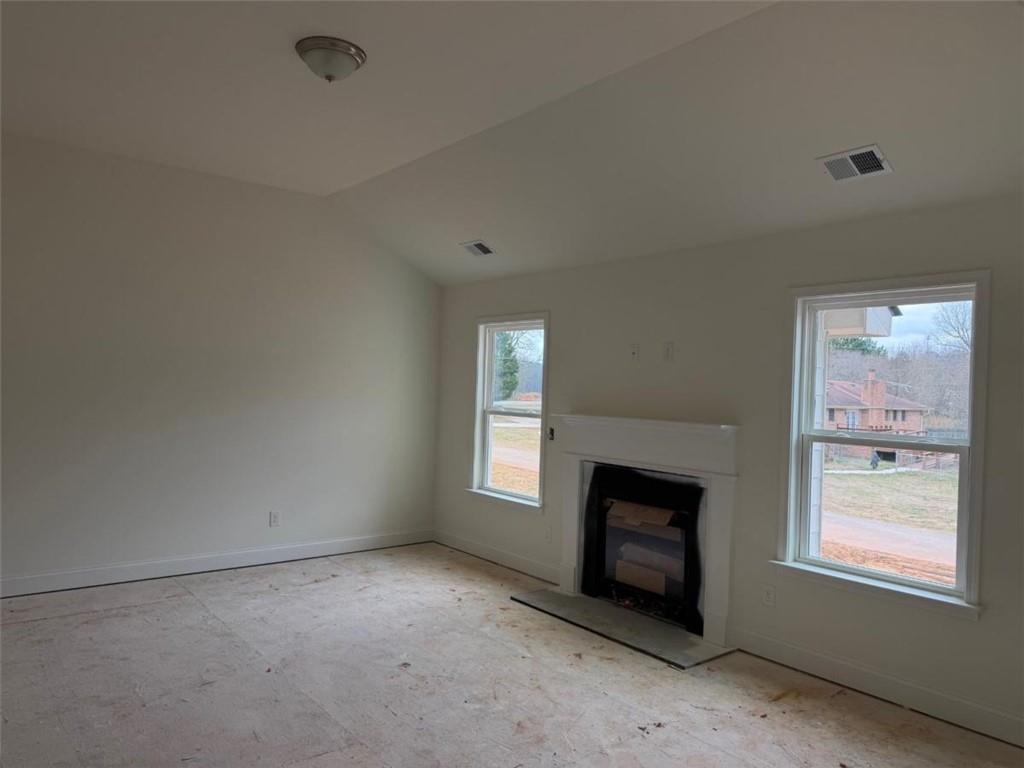 41 Woodland Road Covington, GA 30016 - Photo 6 of 35 a view of an empty room with window and fire place