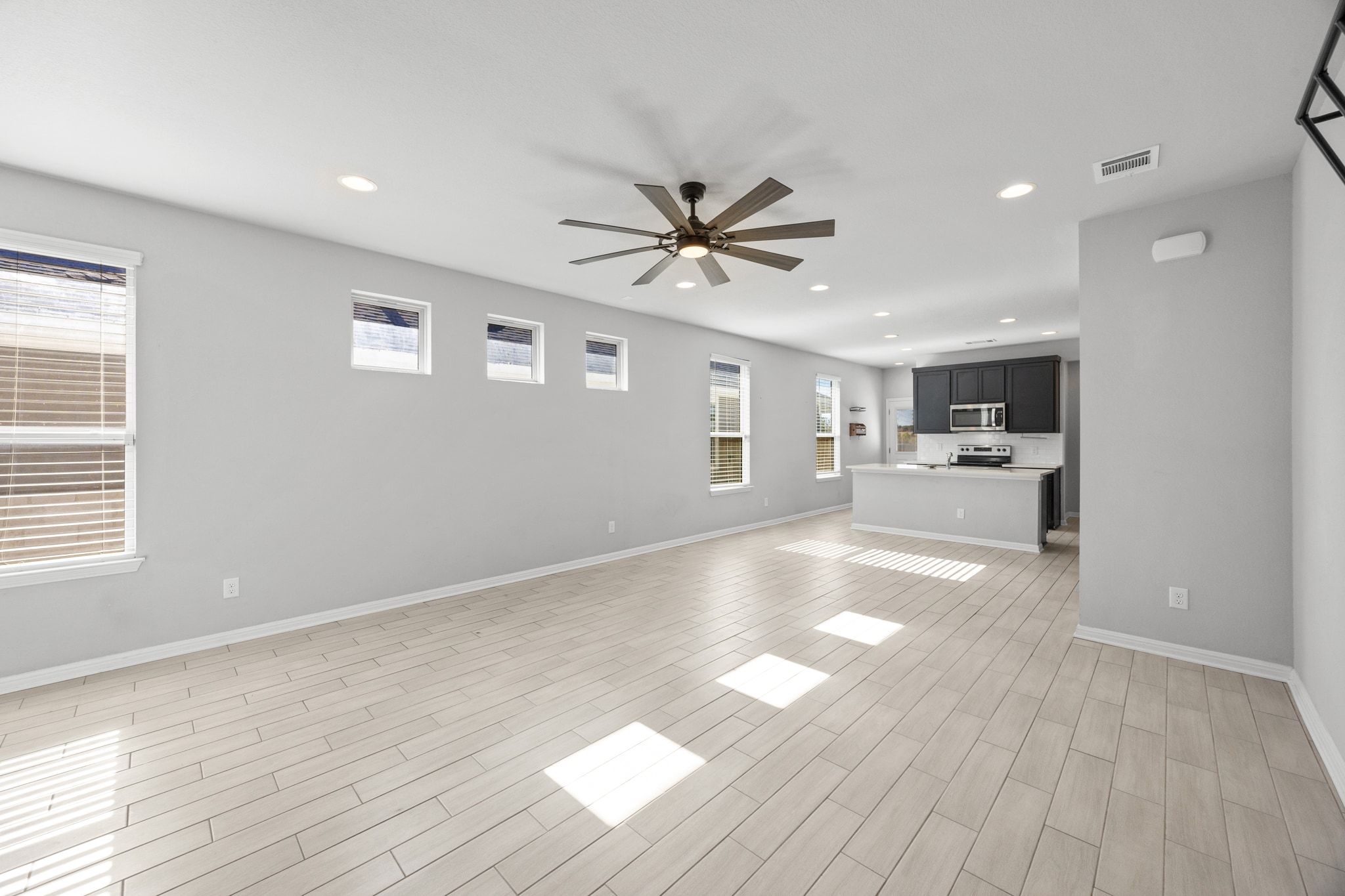225 Unforgiven Lane Jarrell, TX 76537 - Photo 6 of 30 Unfurnished living room with recessed lighting, wood finish floors, and a ceiling fan