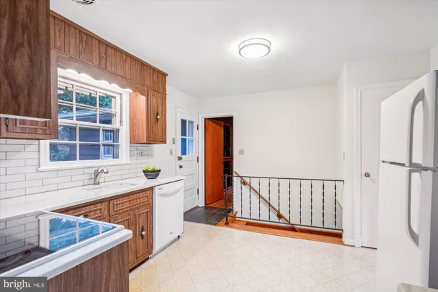 a view of a kitchen from a sink and a window