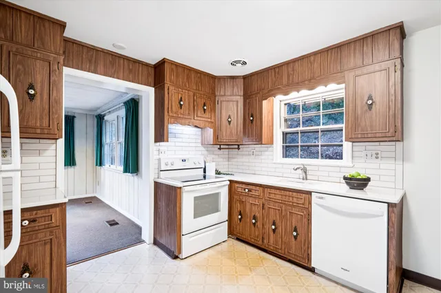 a kitchen with stainless steel appliances granite countertop a stove and a sink